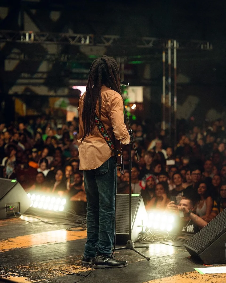 Artist on stage facing the crowd, from the VAGOS archive